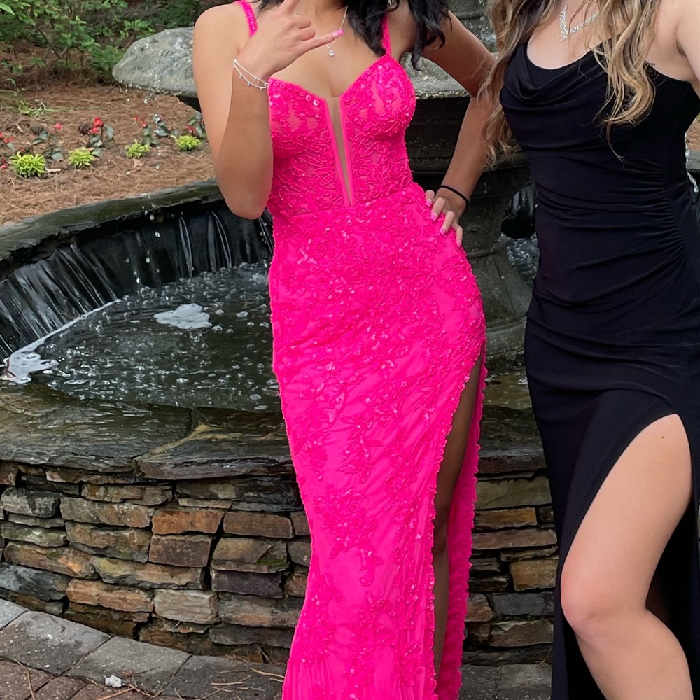 Long pink formal gown with bead detailing and slit